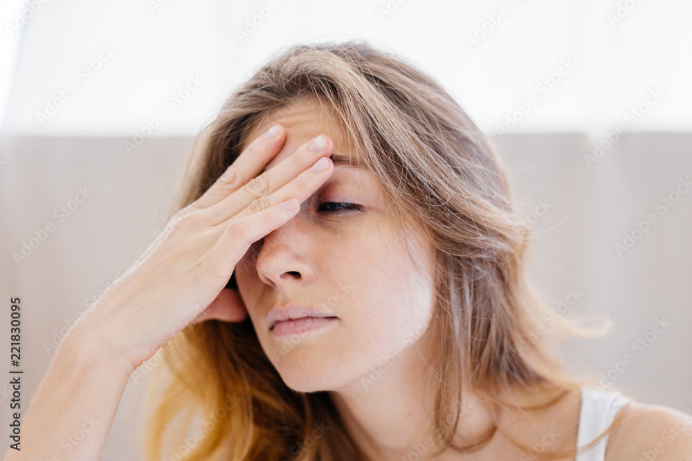 Fototapeta premium a portrait of a woman stretching in bed after wake up