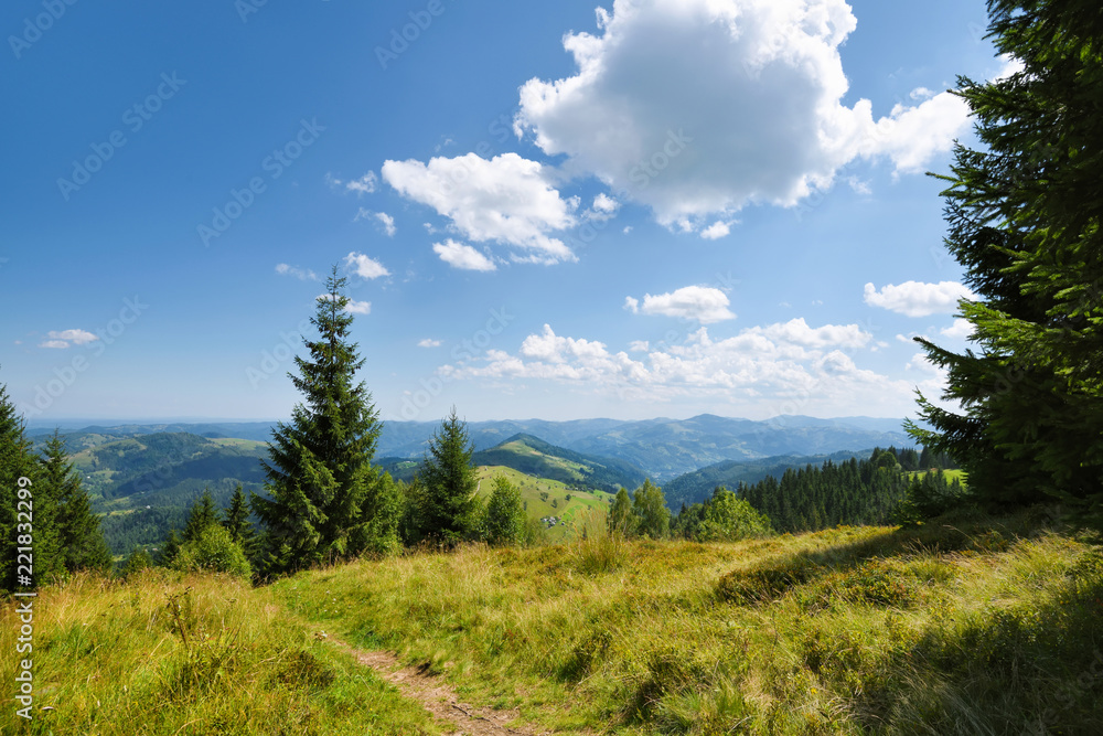 Summer landscape in mountains and blue sky with clouds