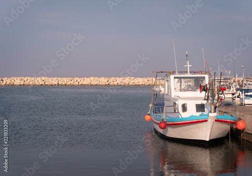 a fishing boat in a sea bay. sunset