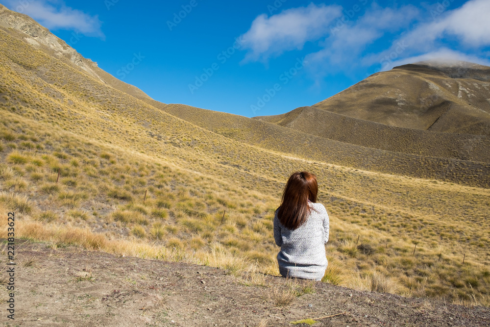 Hipster girl traveller at yellow hill Lindis Pass, New Zealand. . Hipster girl traveller at yellow hill Lindis Pass, New Zealand. .