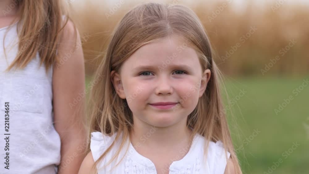 Cute smile child girl portrait posing on nature - happy childhood Cute smile child girl portrait posing on nature - happy childhood