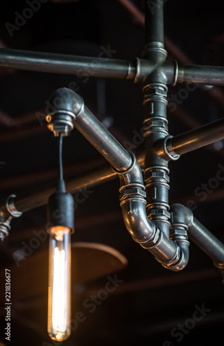 Pipes, fittings and lamp on dark background