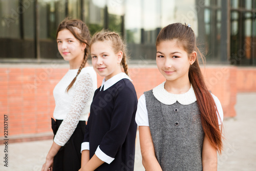 cute group girls teenages sitting outside school buildings