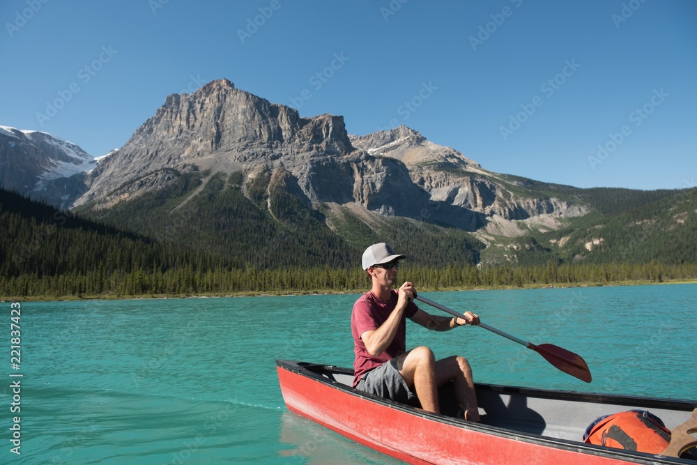 Man rowing a boat on river Man rowing a boat on river