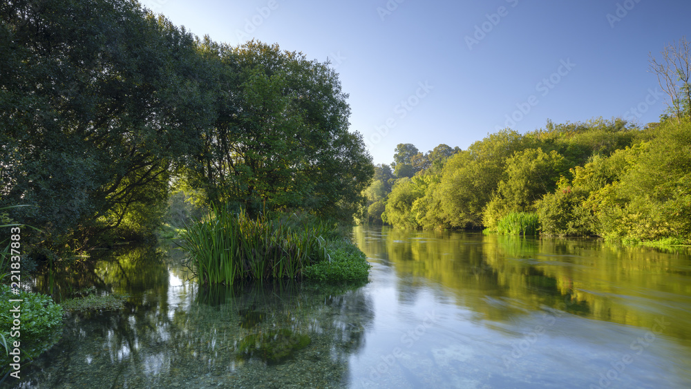 Autumn sunrise on the River Itchen - a famous chalk bed stream renowned for fly fishing - between Ovington and Itchen Abbas in Hampshire, UK.