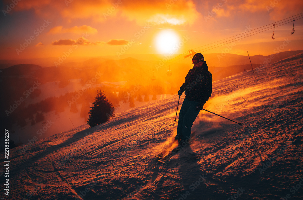 DONOVALY, SLOVAKIA, 5. JANUARY, 2017: Skier in Jasna ski resort, sunset light in background