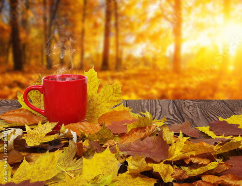 Autumn leaves and hot steaming cup of coffee.