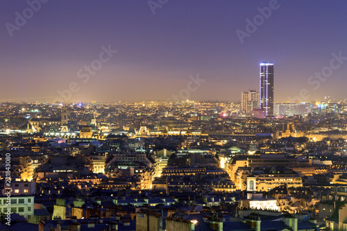Beautiful Paris night cityscape seen from Montmartre with the tour Montparnasse skyscraper at night