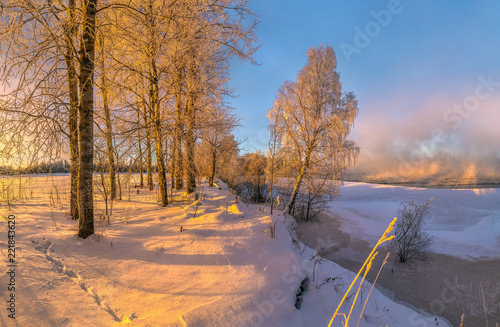 Hoarfrost on the river. Winter frosty dawn. Trees in the hoarfrost. North of Russia.