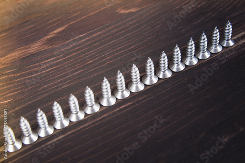 screws on wooden background