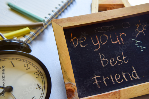 be your best friend phrase colorful handwritten on chalkboard, alarm clock with motivation and education concepts.