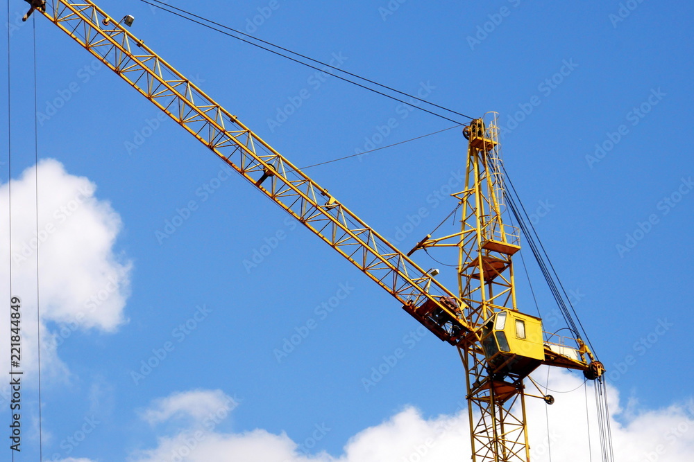 Crane. Industrial crane against blue sky. Construction site.