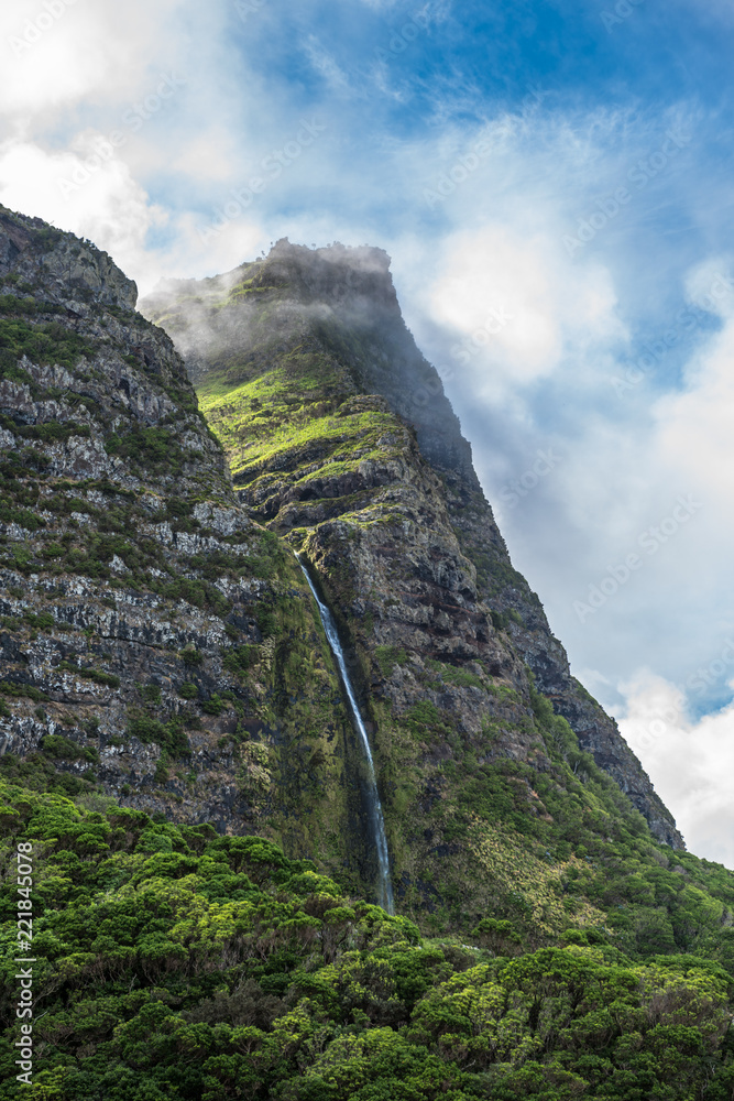 Obraz premium Cascata do Poço do Bacalhau, a waterfall on the Azores island of Flores, Portugal.