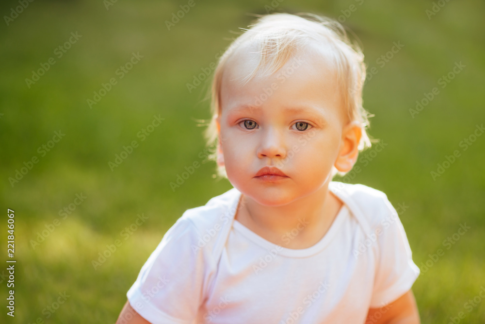 Funny blond toddler boy in summer garden Funny blond toddler boy in summer garden