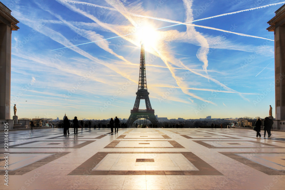 Beautiful backlit Eiffel tower seen from Trocadero square with a dramatic sky in winter 