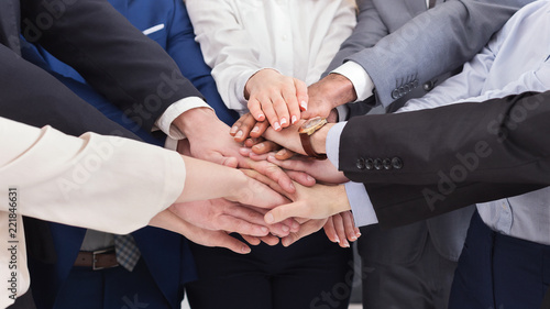 Business people putting hands together in office