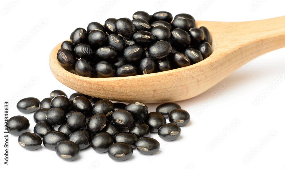 raw black bean in the wooden scoop, isolated on white raw black bean in the wooden scoop, isolated on white