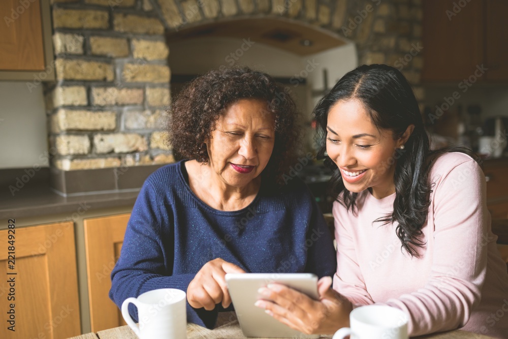 Mother and daughter using digital tablet Mother and daughter using digital tablet