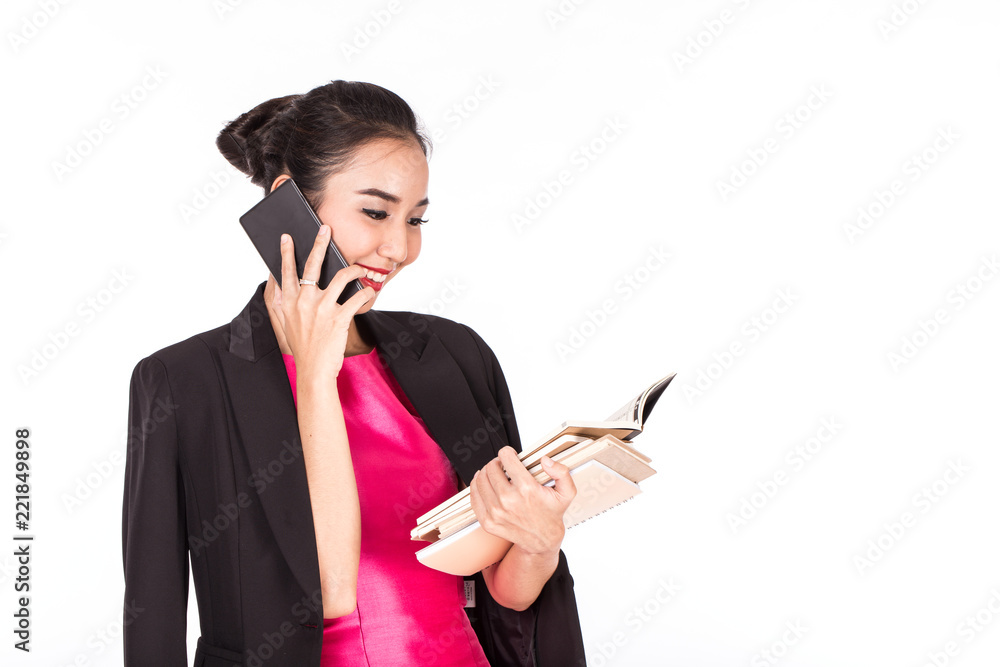 Beautiful Attractive Asian woman talking in smartphone and looking book in her hand feeling so happiness,Isolated on white background Beautiful Attractive Asian woman talking in smartphone and looking book in her hand feeling so happiness,Isolated on white background
