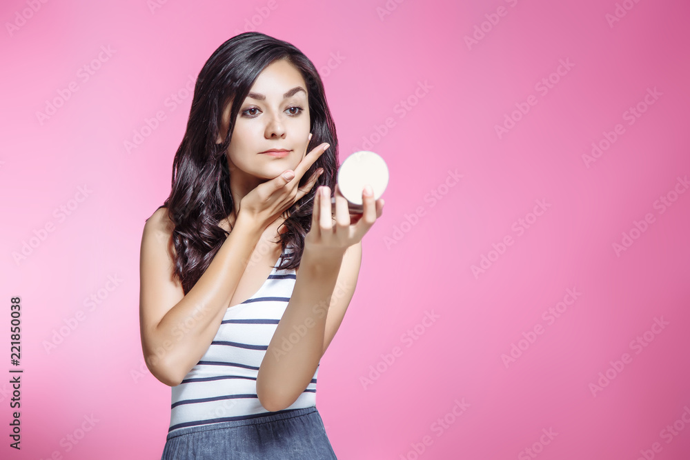 Portrait of beautiful young woman with mirror on pink background. Portrait of beautiful young woman with mirror on pink background.