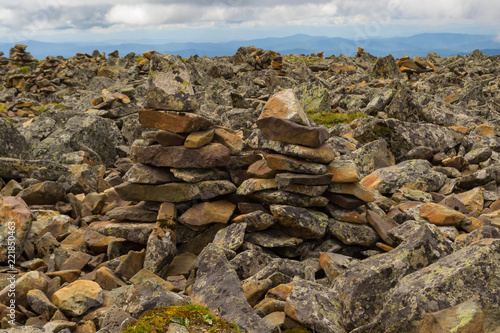 Two towers at the top of the Sarlyk mountain from the stones stacked on each other, balancing in the air, indicating the way for tourists and pilgrims where to go so as not to get lost in the Altai. © Aleksandr Kondratov