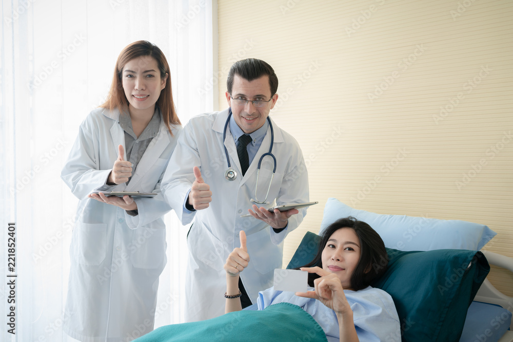 Smiling doctor and patient be happy when using blank credit card for paying medical bills. Smiling doctor and patient be happy when using blank credit card for paying medical bills.