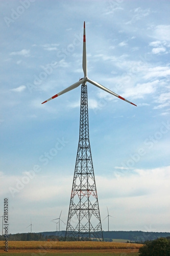 wind turbine with lattice mast, other windmills in background