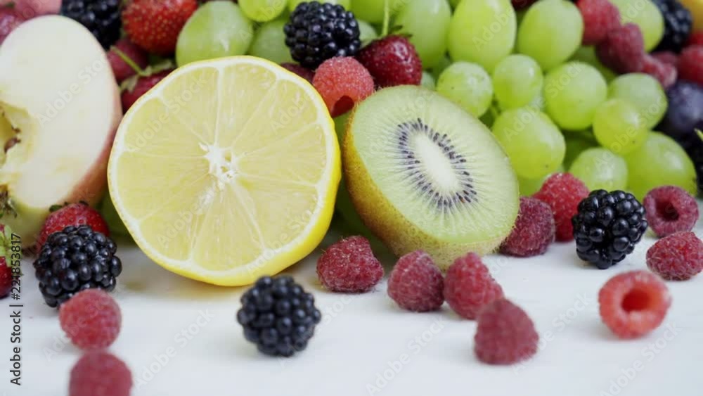 Beautiful mixed berries and fruit on white background. Close up. Natural healthy food. 4K