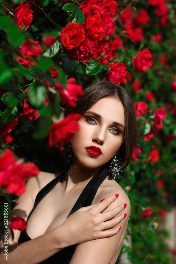 Portrait of beautiful young woman in the rose garden, spring time, rose flowers blossoms. Portrait of beautiful young woman in the rose garden, spring time, rose flowers blossoms.