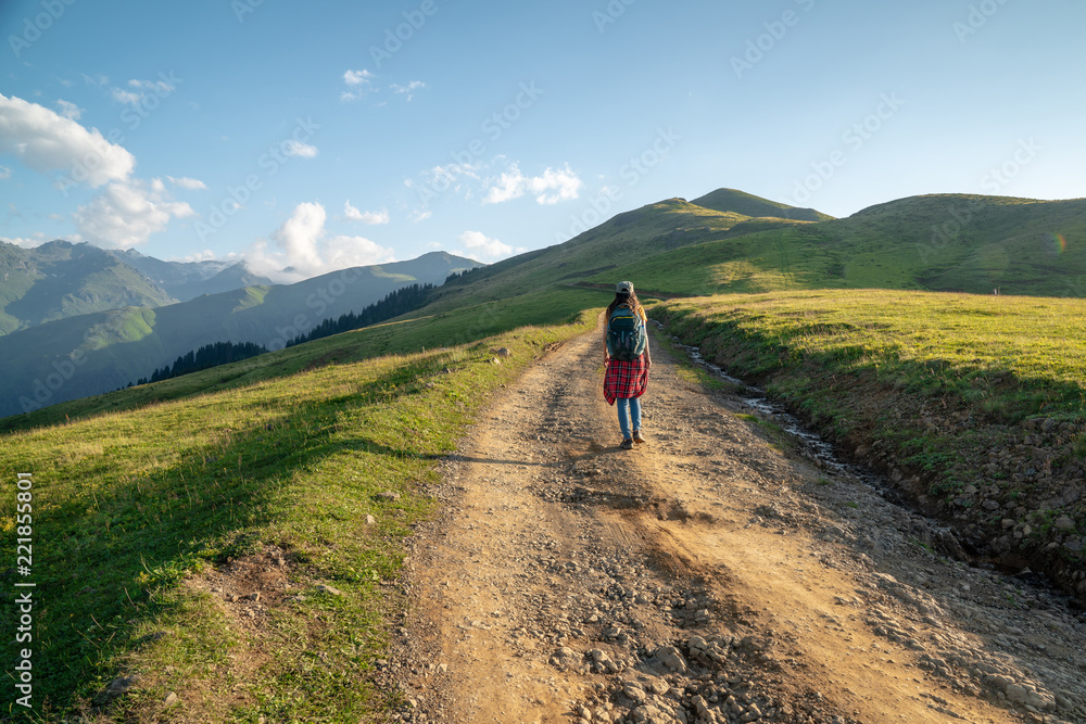 Young Woman with backpack walking on path.Travel Concept.
