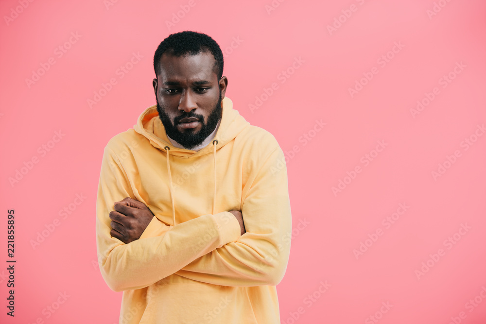 frustrated african american man with crossed arms isolated on pink background frustrated african american man with crossed arms isolated on pink background