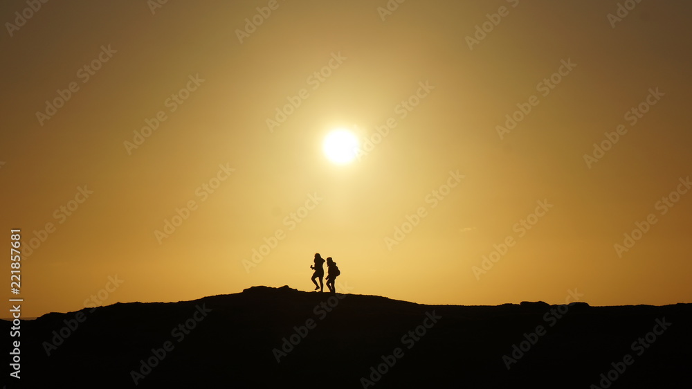Silhouette Couple Walking against an Golden Sunset