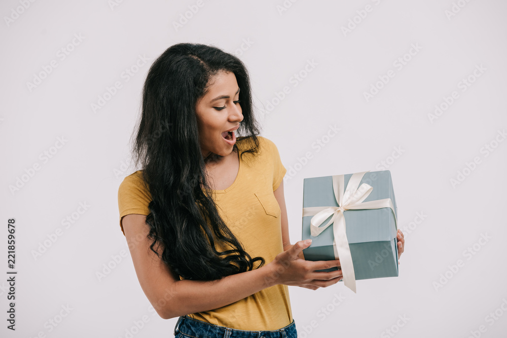 excited african american girl looking at present box isolated on white excited african american girl looking at present box isolated on white