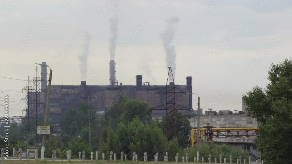 A big stovepipe smokes on the mining and processing plant. aerial shooting 4K A big stovepipe smokes on the mining and processing plant. aerial shooting 4K