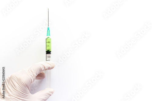 Hand holding syringe inject...