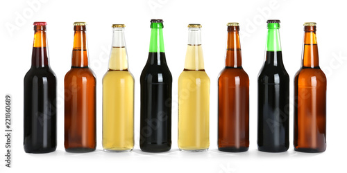 Bottles with different beer on white background