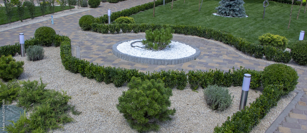 Cobbled concrete paving slab track in a beautifully manicured garden Cobbled concrete paving slab track in a beautifully manicured garden