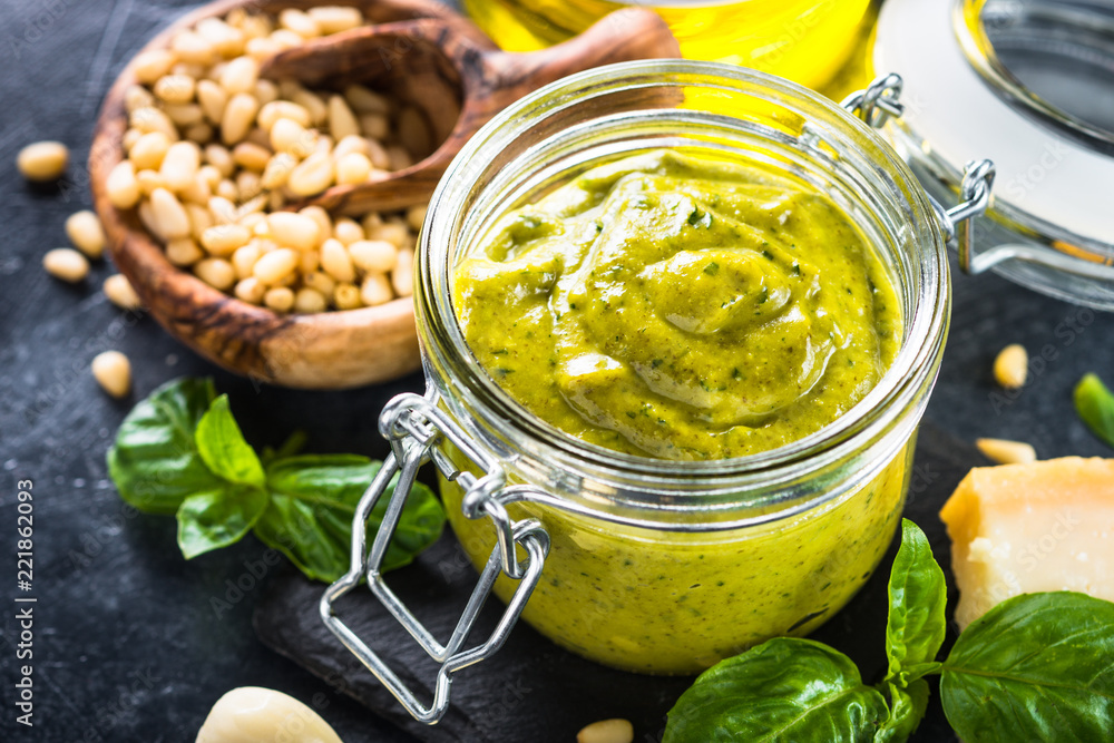 Pesto sauce with ingredients on dark stone table. Pesto sauce with ingredients on dark stone table.