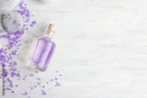 Fototapeta Naklejka Na Ścianę i Meble -  Flat lay composition with natural lavender oil on wooden background. Space for text