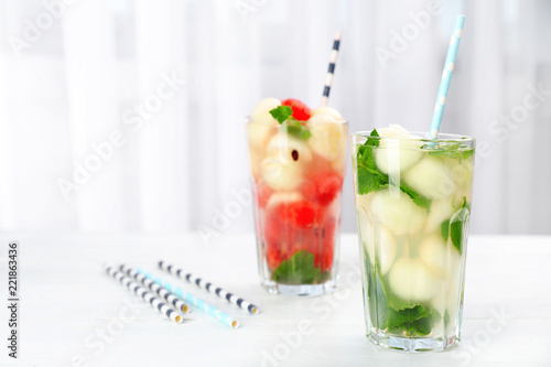 Tasty watermelon and melon ball drink in glasses on table