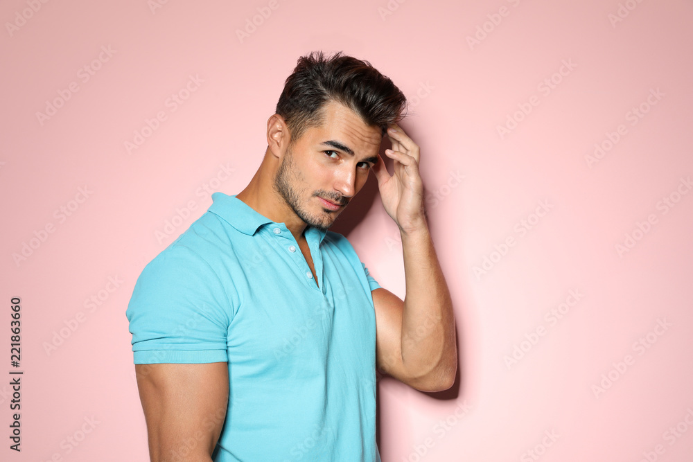 Young man with trendy hairstyle posing on color background Young man with trendy hairstyle posing on color background