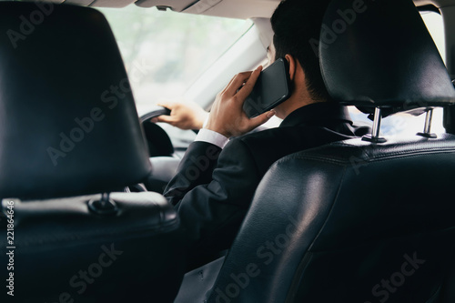 Young business man with phone in car. © ijeab