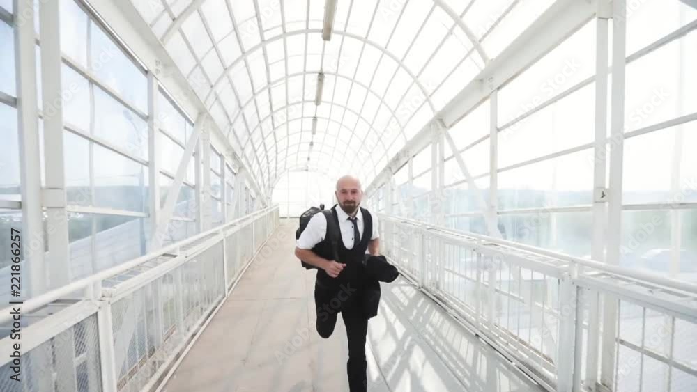 slow motion of business man traveler running in hurry in the airport slow motion of business man traveler running in hurry in the airport