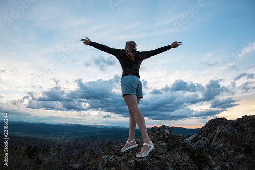 Travel, lesure and freedom concept - woman on the top of Altai mountain, beauty summer evening landcape
