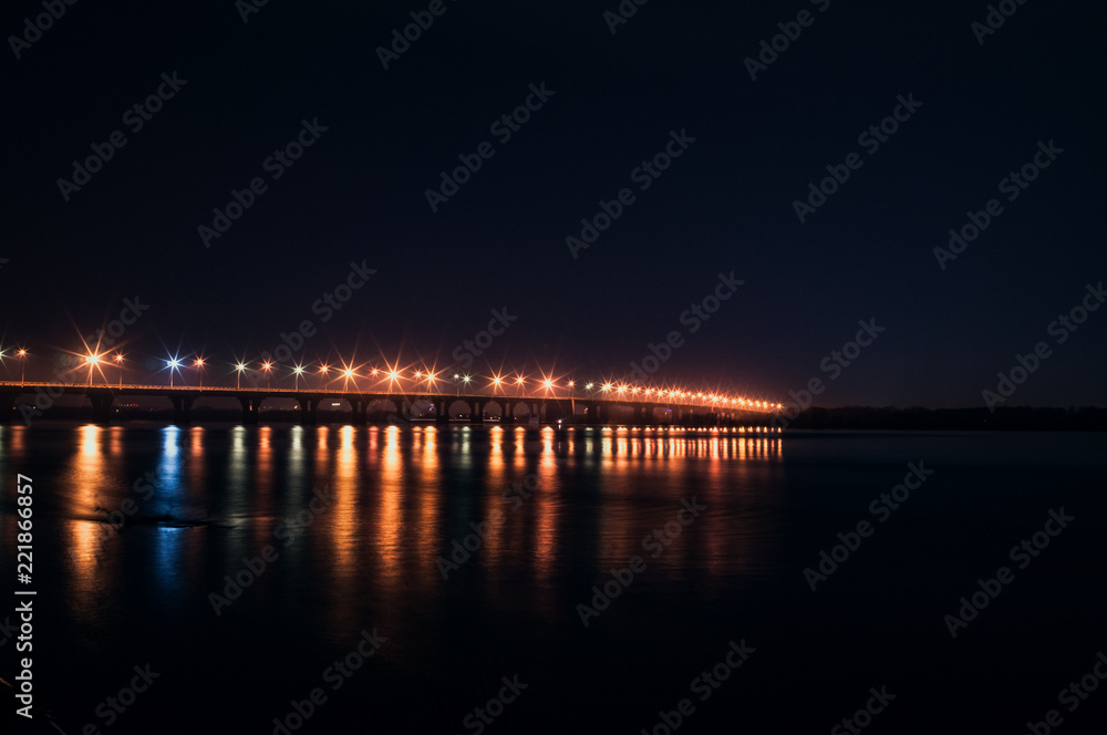 The lights of the bridge over the river at night