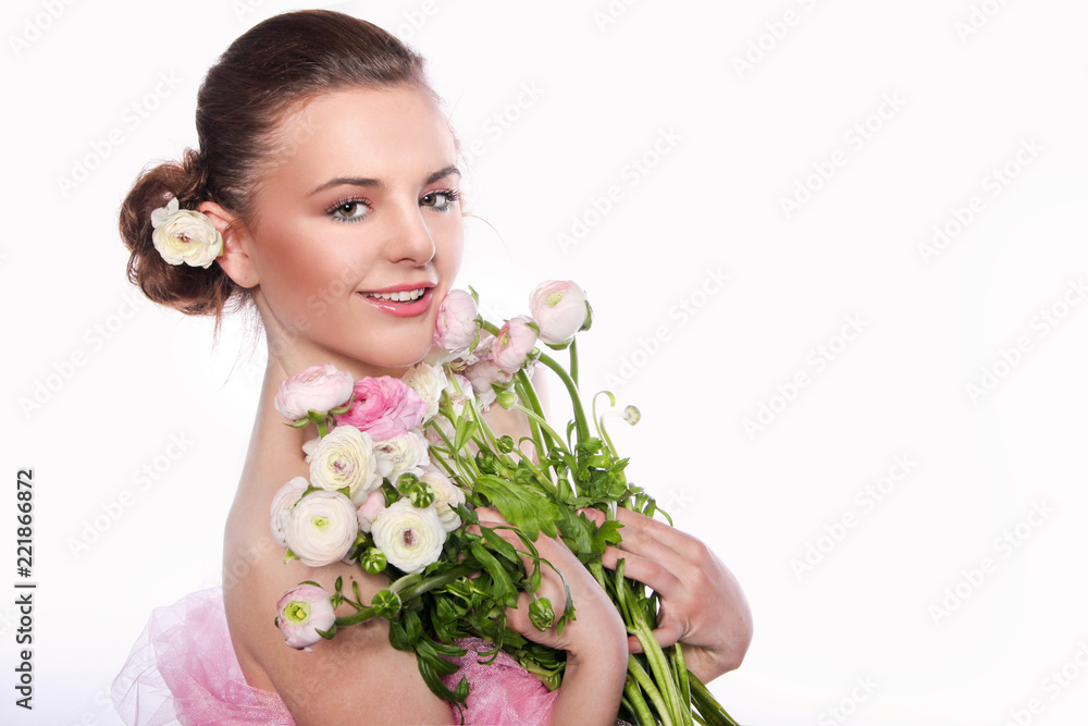 ..Young beautiful woman with a bouquet of tender spring flowers over white background, ranunculus.
