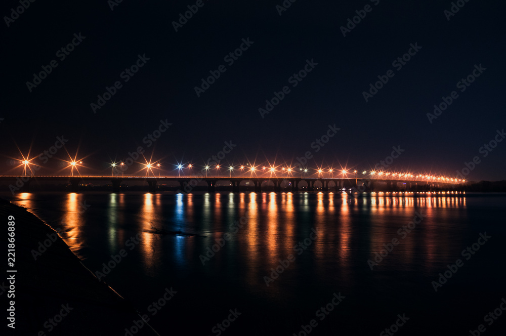The lights of the bridge over the river at night