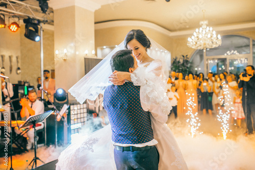Obraz na płótnie brides wedding party in the elegant restaurant with a wonderful light and atmosphere. Newlyweds dancing with fireworks. w salonie