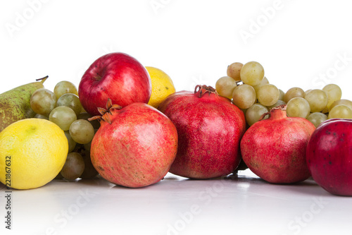 pomegranates and other fruits on a white background