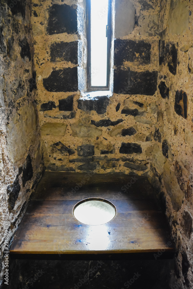 Old stone toilet in Tower of London with wooden floor. Medieval latrine ...